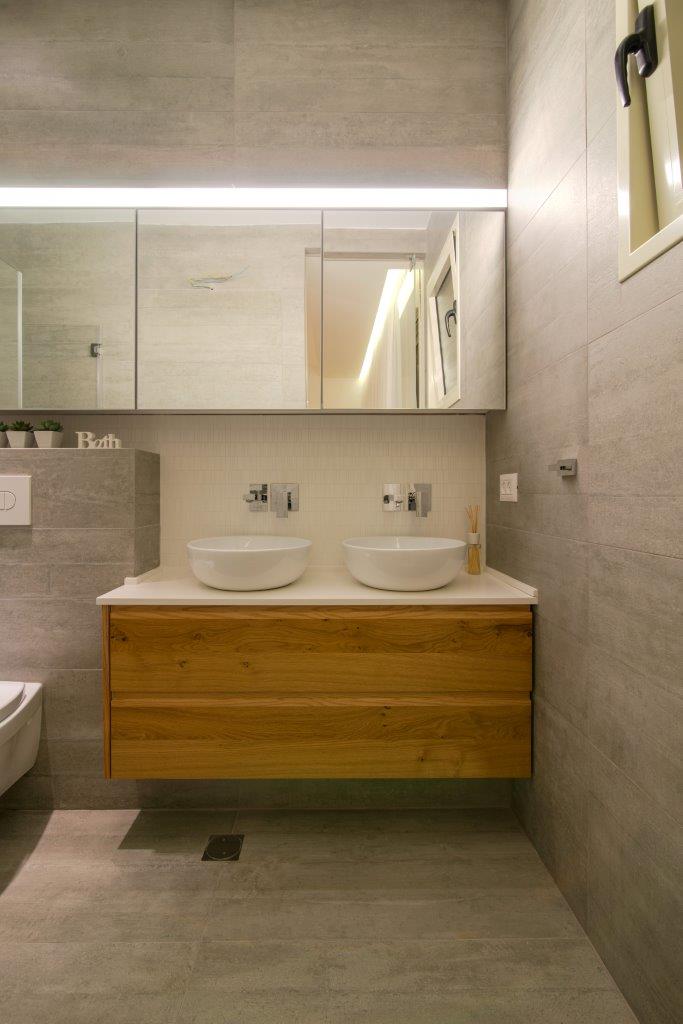 The oak unit with its two basins — a double basin for getting ready in the morning, and an LED profile set the length of the mirror as one continuous line