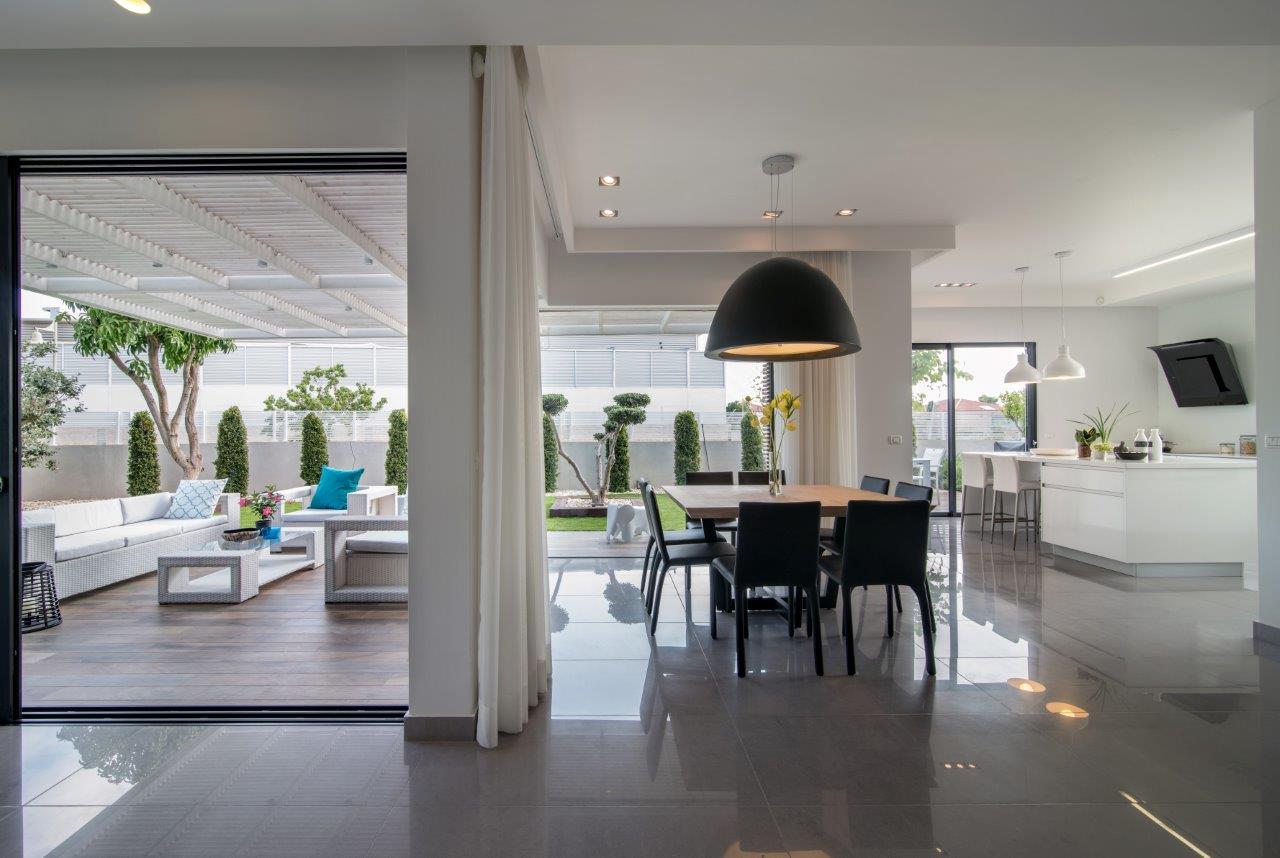 The dining area looking out to the terrace and garden, doors open